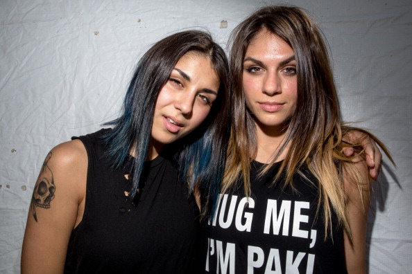 INDIO, CA - APRIL 20:  Yasmine Yousaf (L) and Jahan Yousaf of Krewella pose backstage at the Coachella valley music and arts festival at The Empire Polo Club on April 20, 2014 in Indio, California.  (Photo by Chelsea Lauren/WireImage)